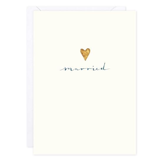 A cream-colored card with a gold foil heart in the middle, and underneath the heart, the card says Married.