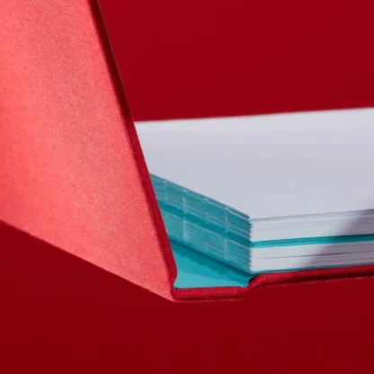 Berry Red Hardcover Notebook. Binding. Side shot of the Swiss-bound berry red notebook.