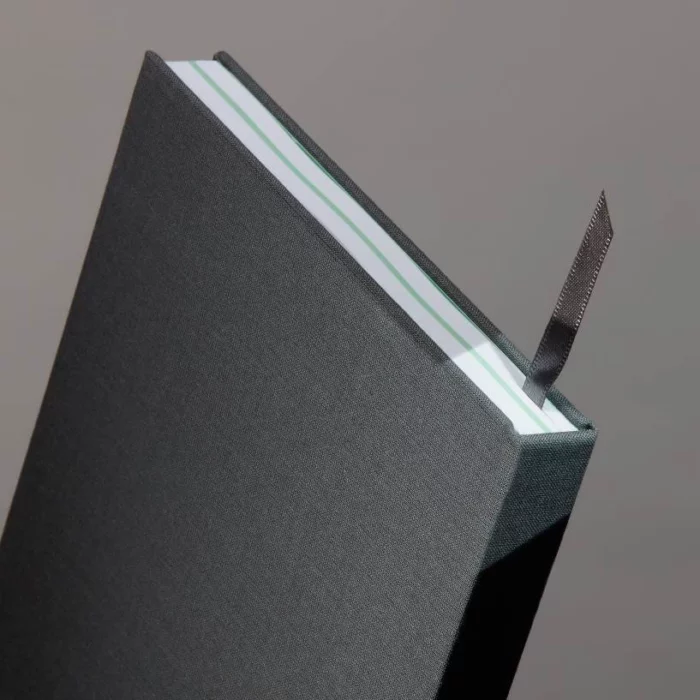 Charcoal Grey Hardcover Notebook. Ribbon. Side shot of the charcoal grey notebook, with the placeholder ribbon in charcoal grey.