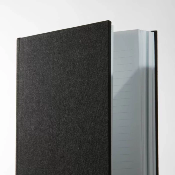 Jet Black Hardcover Notebook. Lined. Side shot of the cloth jet black notebook, showing lined pages.