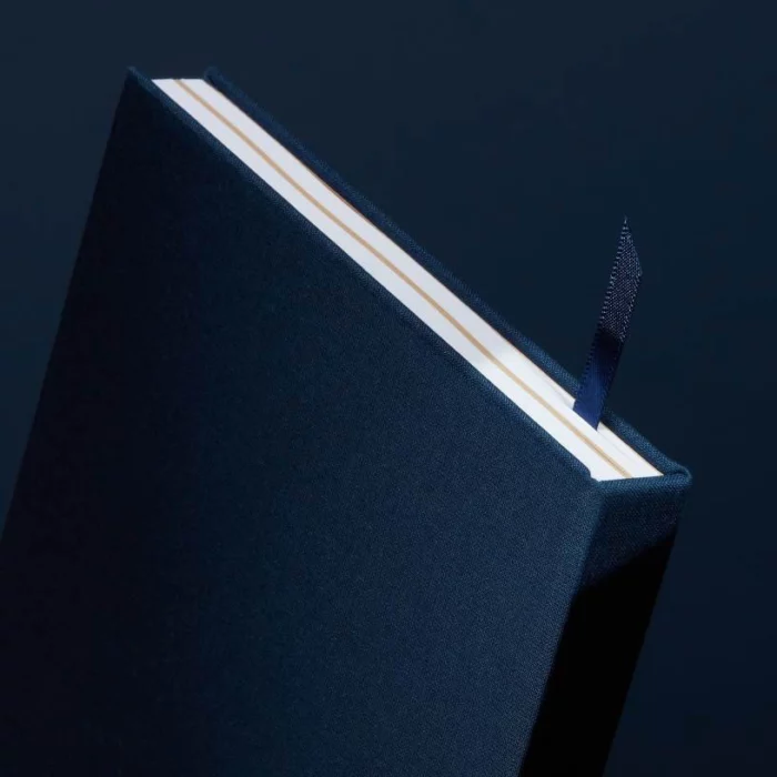 Midnight Blue Hardcover Notebook. Ribbon. Side shot of the midnight blue notebook, with the placeholder ribbon in midnight blue.