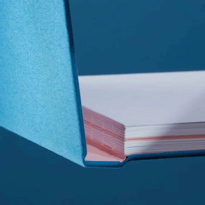 Sky Blue Hardcover Notebook. Binding. Side shot of the Swiss-bound sky blue notebook.