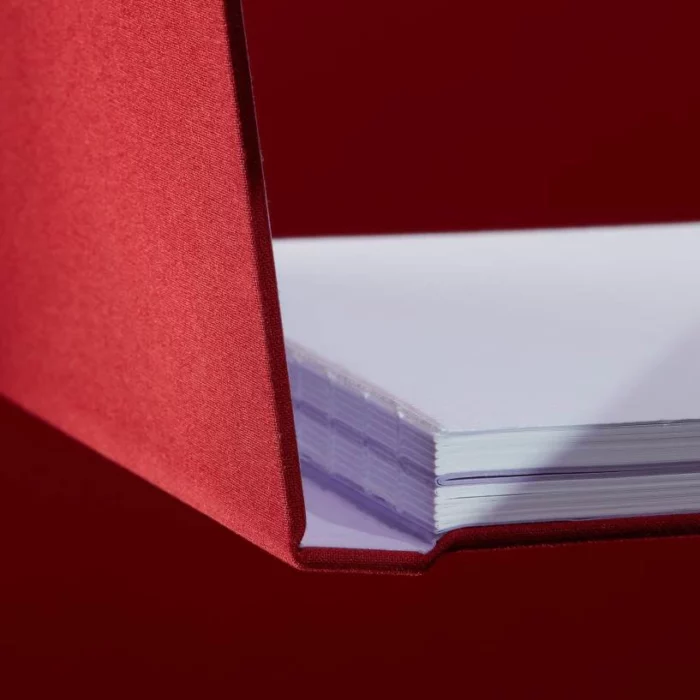 Wine Red Hardcover Notebook. Binding. Side shot of the Swiss-bound wine red notebook.