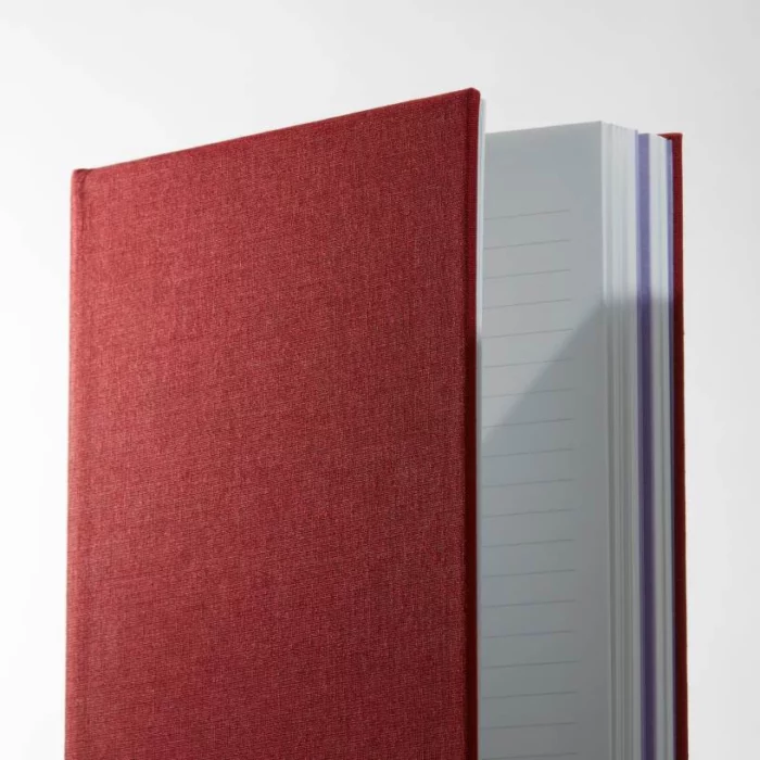 Wine Red Hardcover Notebook. Lined. Side shot of the cloth wine red notebook, showing lined pages.